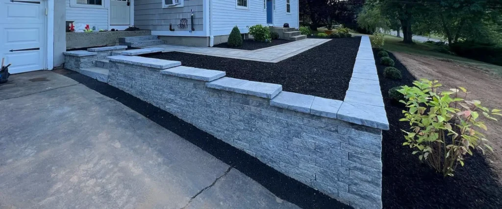 Frontyard retaining wall with surrounding garden beds