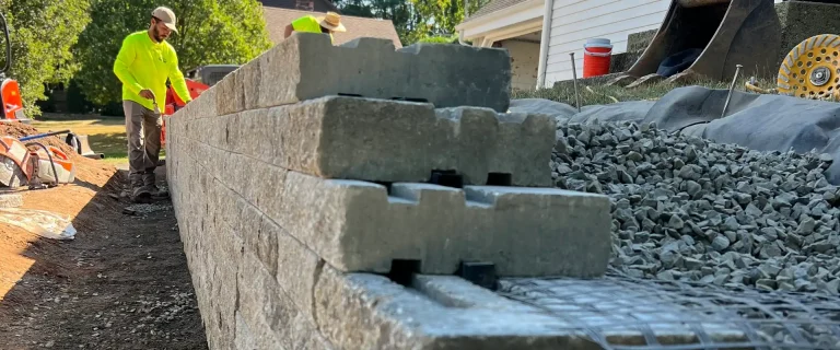 retaining wall under construction and showing wall courses and backfill