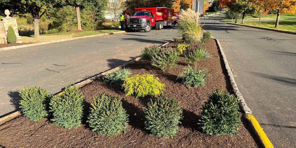 Scenic Landscaping Truck and Crew In Front Of Newly Renovated Garden Beds